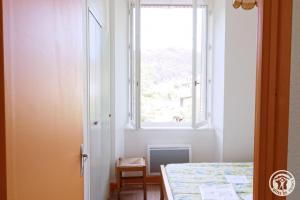 Un dormitorio con una cama y una ventana en Gite ecole, en Soursac