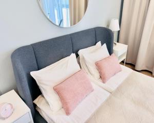a couch with two pillows on it with a mirror at Old Town Walowa in Gdańsk +80 photos