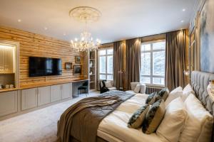 a bedroom with a large bed and a flat screen tv at Skýra Retreat in Rovaniemi