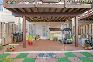 a patio with a wooden deck with chairs and a grill at Fireplace • Grill • Gym‑Ready • Near Bull Run in Centreville