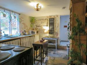 a kitchen with a counter and a table in it at The Annexe Lurley Manor in Tiverton