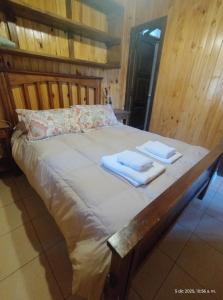 a bed with two towels on top of it at Cabañas Viña Aliwen in Vistalba +26 photos