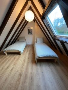 En eller flere senge i et værelse på Le chalet de Pfaffenbronn