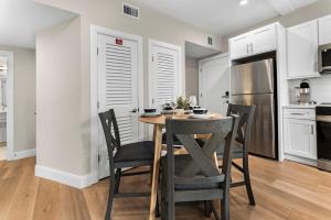 a kitchen with a table and chairs and a refrigerator at Luxury 2BR near Cabmridge in Somerville