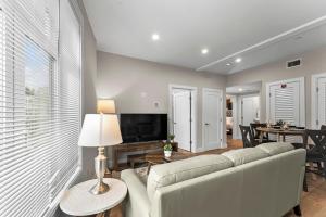 a living room with a white couch and a television at Luxury 2BR near Cabmridge in Somerville +29 photos
