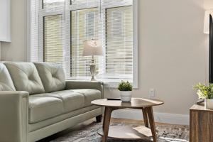 a living room with a couch and a table at Luxury 2BR near Cabmridge in Somerville
