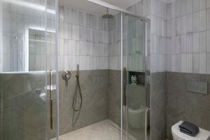 a bathroom with a shower and a toilet at PAREA Athens in Athens