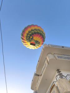 a colorful hot air balloon flying over a building at King House in Luxor