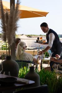a man and woman sitting at a table in a restaurant at Hôtel La Marine - Restaurant Marnage in Barneville-Carteret +79 photos