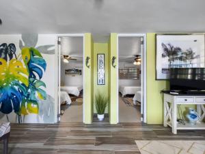 a room with two sliding doors and a room with beds at Tropical Naguabo Beach House Pool n Beach in Naguabo