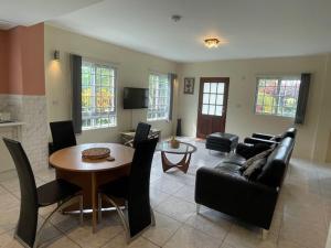 a living room with a table and a couch at Christiana Apartment Morne Daniel in Canefield