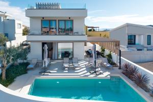 a villa with a swimming pool and a house at Villa Mare Zadar in Zadar