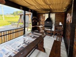 an outside view of a house with a table and a window at Cabana A-Frame Sesu in Cîrlibaba