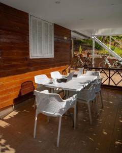 Elegant Family Chalet a Imi Ouaddar Comfort & Calm في أغادير: مجموعة من الطاولات والكراسي البيضاء على الفناء