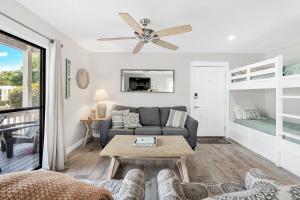 a living room with a couch and a table at One Bedroom at Beachwood Villas on 30a in Seagrove, Florida in Santa Rosa Beach