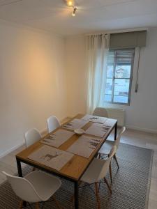 a dining room with a wooden table and white chairs at 3 bedrooms apartment in Fionnay in Fionnay +7 photos