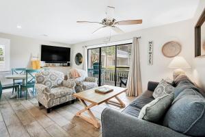 a living room with a couch and chairs and a table at One Bedroom at Beachwood Villas on 30a in Seagrove, Florida in Santa Rosa Beach