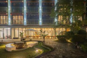 a building with a fountain in front of a building at Yangshuo Courtyard Hotel - An all-English team by the Li River in Yangshuo