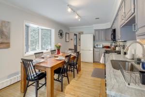 a kitchen and dining room with a wooden table and chairs at 8 Mi to Dtwn Saratoga Springs Quiet Family Home in Gansevoort