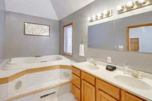 a bathroom with two sinks and a bath tub at 8 Mi to Dtwn Saratoga Springs Quiet Family Home in Gansevoort +22 photos