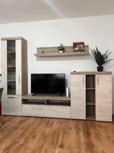 a large entertainment center with a television in a living room at Focus Residence in Miercurea-Ciuc