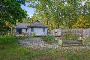 a house with a fence and some plants in a yard at 8 Mi to Dtwn Saratoga Springs Quiet Family Home in Gansevoort