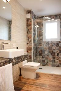a bathroom with a toilet and a sink and a tub at La Caseta del tío Antonio in El Parral +19 photos
