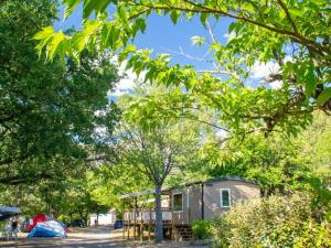 a small house in the middle of some trees at Camping Tikayan Saint Clair - Maeva in Moustiers-Sainte-Marie