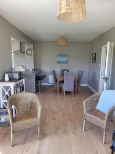 a living room with a table and chairs at Sunny south east in Wexford in Blackwater