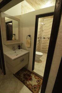 a bathroom with a sink and a toilet and a mirror at hyle Surfhouse in Agadir