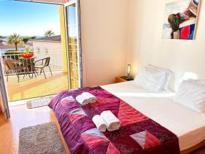 una camera da letto con un letto e un balcone di Balaia Poolside House with Sea View by BeCherish a Branqueira Altre 37 foto