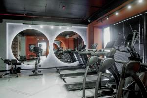 Ein Fitnessstudio mit Laufbändern und Crosstrainern in der Unterkunft U-tower 18 apartment in Chilanzar