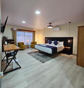 a bedroom with a bed and a living room at Calathea Hotel Monteverde in Monteverde Costa Rica