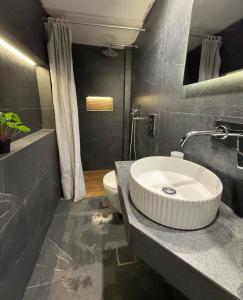 a bathroom with a sink and a toilet at Apartment 105 sq.m. near center in Patra