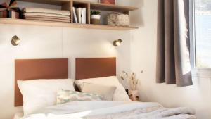 a bedroom with a bed and a shelf above it at Camping Tikayan Saint Clair - Maeva in Moustiers-Sainte-Marie