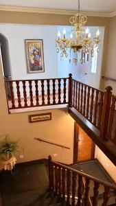 a staircase in a house with a chandelier at Hotel Vitoria Marchi in Serra Negra +36 photos