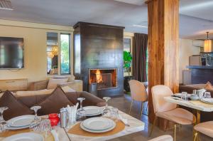a living room with a table and a fireplace at Boutique Hotel Katia in El Harkat