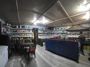 a man standing at a counter in a kitchen at Hotel mardi station in Astam