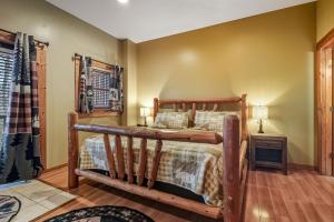 a bedroom with a wooden bed in a room at Tranquil View by American Patriot Getaways in Glade