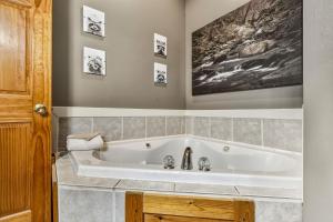 a white bath tub in a bathroom with at Tranquil View by American Patriot Getaways in Glade +50 photos