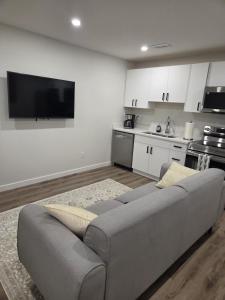 a living room with a couch and a kitchen at The Heavenly Crib in Saskatoon