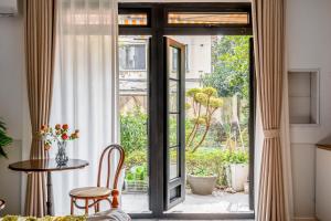 an open door to a patio with a table and chairs at Changle Road in Shanghai