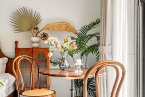 a table with a vase of flowers and two chairs at Changle Road in Shanghai +7 photos