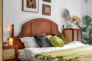 a bedroom with a bed with a wooden headboard and pillows at Changle Road in Shanghai