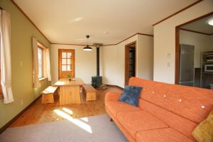 a living room with a couch and a table at THE KOYA Nagano in Nagano