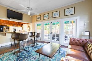 a living room with a couch and a bar with chairs at Curry House - Room 5 in Key West