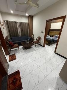 een woonkamer met een blauwe bank en een tafel bij kohistan Enclave wah cantt 