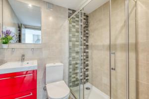 a bathroom with a toilet and a glass shower at Estepona Real Apartamentos in Estepona +15 photos