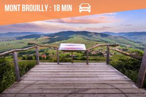 a wooden boardwalk with a view of a mountain at T2 proche autoroute et gare in Belleville-en-Beaujolais +4 photos