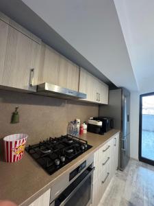 a kitchen with a stove top oven in a kitchen at Madona Apartment in Craiova